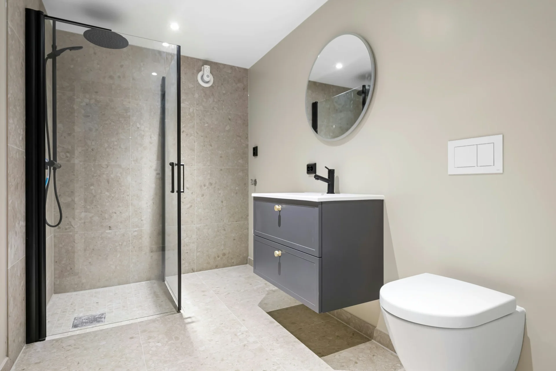 Affordable walk-in shower remodel in Aurora featuring a space-saving corner glass enclosure, classic white subway tiling, and a chrome rainfall showerhead.